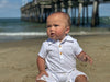 white, pique, polo, romper, button, buttons, collar, baby, playing, on, beach, spring, summer, henry,