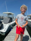 Navy, lobster, printed, tee, red, shorts, curly, hair, boy, standing, on, pier, next, to, the, boats, casual, look, summer, henry,