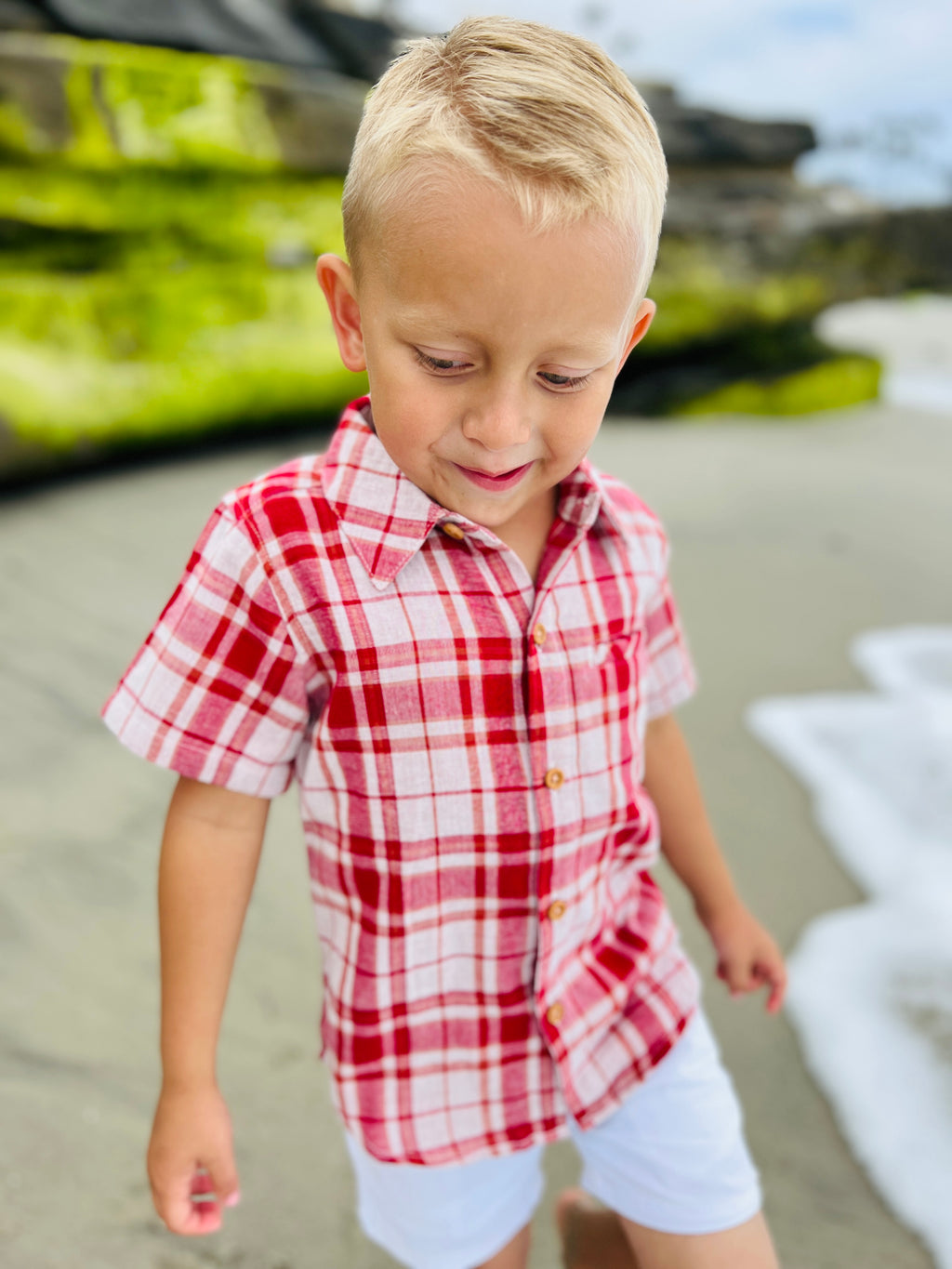 blonde hair boy wearing the red/cream plaid woven shirt and white twill shorts.