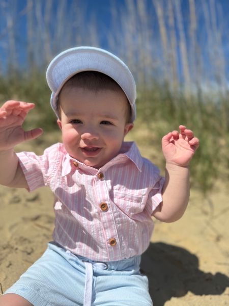 sky, blue, woven, cap, pink, white, onesie, pale, blue, shorts, little, boy sitting, in, sand, with, his, hands, up, summer, henry.