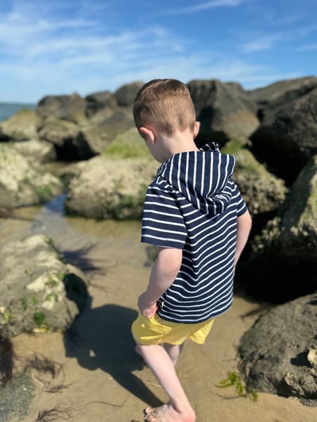 Boy playing on the rocks ,wearing a Navy/ white, Stripped, Stripes, Stripe, Hooded ,Top Short ,Sleeves, Sleeved, Sleeve ,Lemon ,Shorts, Henry.