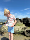 Fair Hair boy playing on the shoreline in Blue Shorts, Pink/Aqua  Stripe, Stripped, Stripes, Polo, short sleeved, Sleeves, Sleeve, by Henry