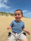 navy, ribbed, onesie, button, buttons, twill, shorts, black, hair, little, boy, sitting, on, his, legs, in, the, sand, summer, henry,