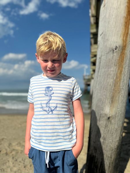 Boy, wearing, blue, anchor, tee, blue, shorts, hands, pocket, fair, hair, at, the, beach, summer, henry.