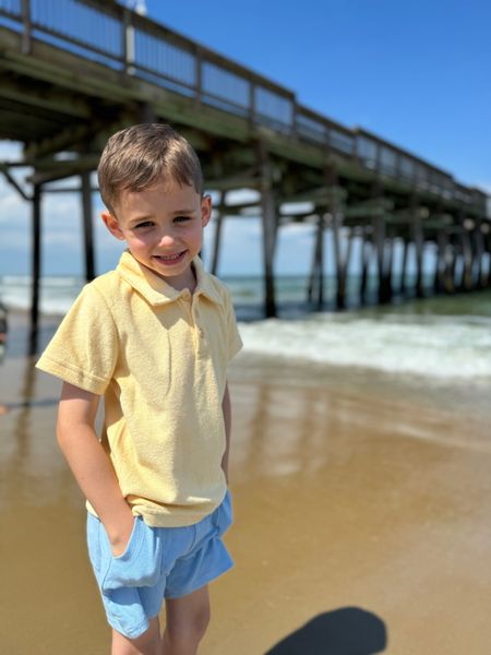 Boy wearing Lemon Terry Towelling Polo in front of pier short sleeved, sleeves, sleeve, Blue ,Shorts by Henry.