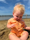 tangerine, henry, print, Henley, romper, button, buttons, pocket, fair, hair, little, baby, sitting, looking, at, the, sand, spring, summer, henry.