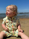 little, boy, sitting, on, the, beach, fair, hair, lemon, surfboard, printed, romper, button, buttons, collar, pocket, spring, summer, henry, 