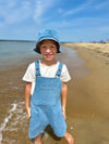 Boy, wearing, indigo, denim, buckled, overalls, white, tee, matching, indigo, denim, bucket, hat, summer, henry.