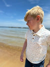 Blonde boy in Tan/Pink Polo Fish print ,short, sleeved ,sleeves ,sleeve by Henry