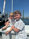 navy, boat, printed romper, button, buttons, collar, tan, sandals, little, boy, walking, on, the boardwalk, spring, summer, henry, Matching Brother.