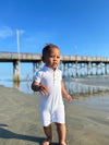white, pique ribbed, polo romper, button, buttons, little, boy, walking, along, the, beach, spring, summer, henry   .
