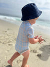 Navy, twill, bucket , hat, baby, boy, on, beach, wearing, blue, stripe, stripes, striped, onesie, rubbing, his, hands, together, summer, henry.