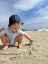 Navy, twill, bucket , hat, baby, boy, wearing, blue, stripe,  stripes, striped, onesie, baby, making, lines, in, the, sand, summer, henry.
                  