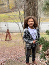 Curly, hair boy standing in front a tree, Black/White, Lumberjacket, Grey, print, Henley, Charcoal, jeans, Warm,  Smart, Autumn, Winter, casual.