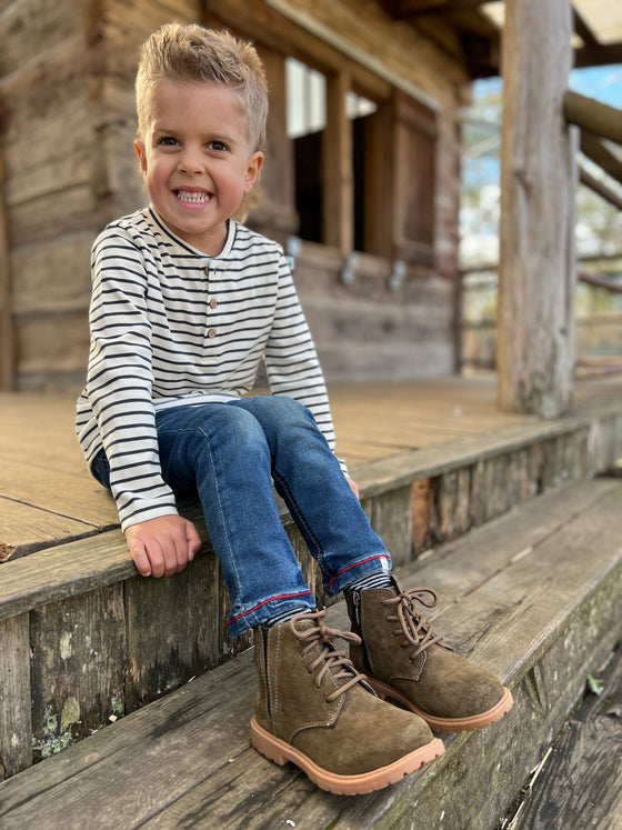 Boy wearing Black/White strip tee, Blue Jeans, Fern Suede Boots, rubber, sole.