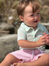 Boy playing in the sand in a Mint/White stripe Jersey onesie, Pink shorts